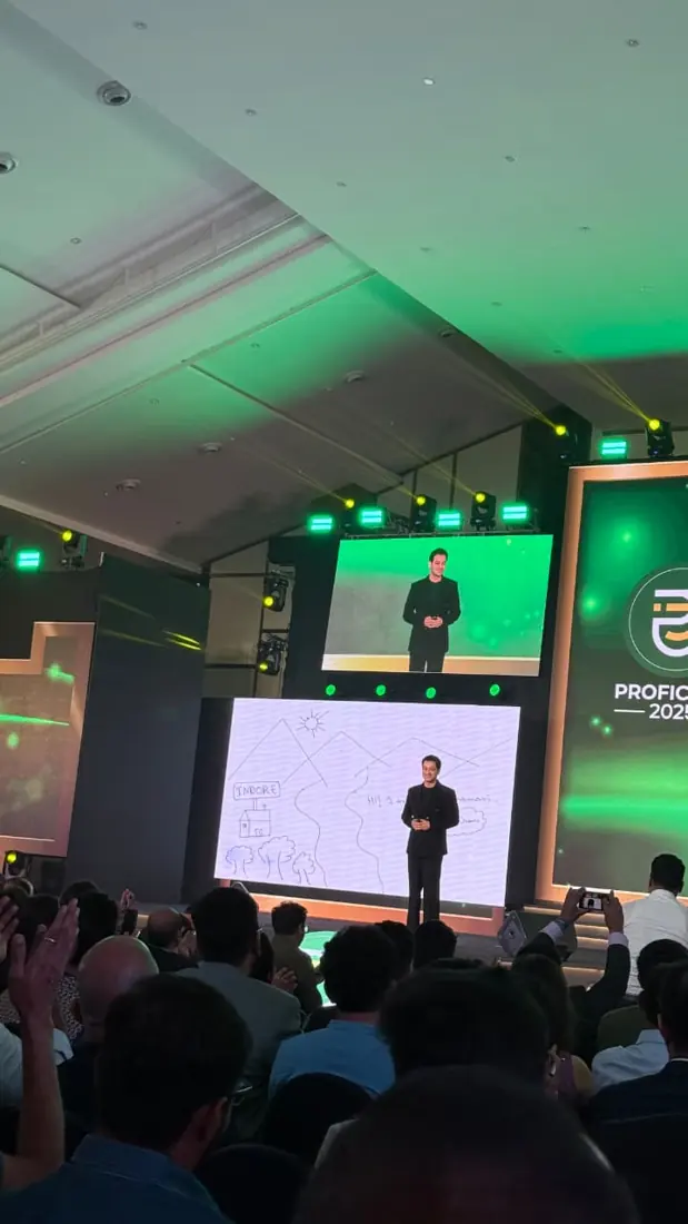 A speaker on stage at Proficorn 2025