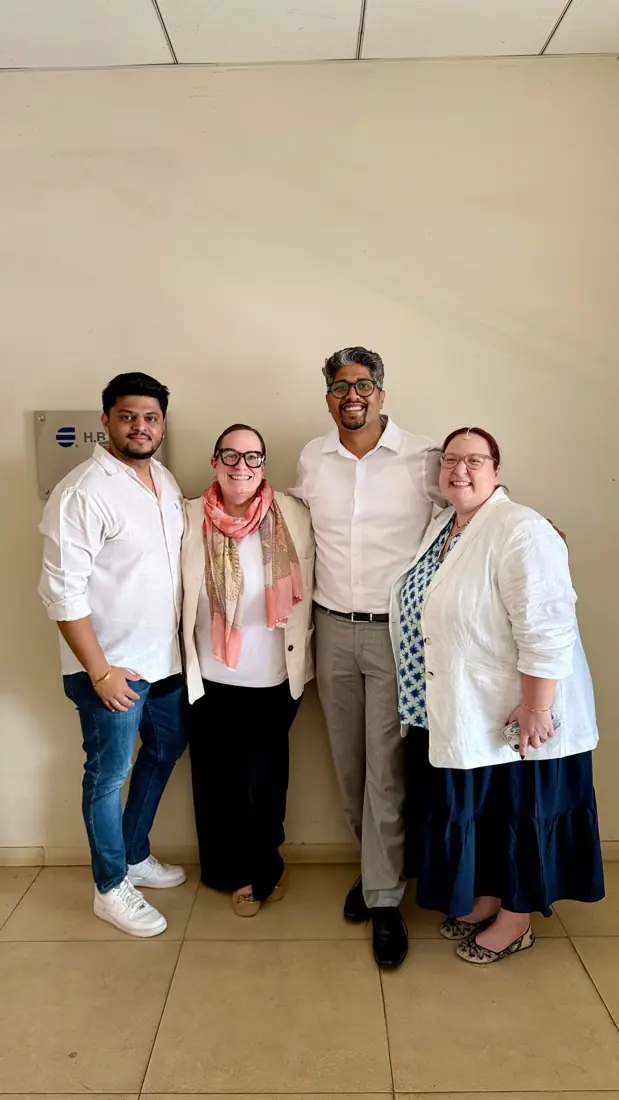 Yuvraj and a colleague with two visiting clients at the client’s office in Pune